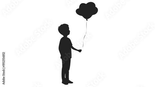 Young boy holding heart shaped balloon silhouette