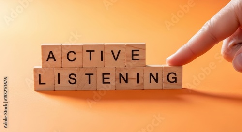 Active Listening Blocks Displayed on Orange Background with Hand
