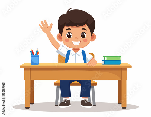 A young boy wearing a school uniform enthusiastically raises his hand while sitting at his desk with school supplies and books in a classroom setting