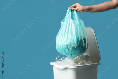 Woman throwing full garbage...
