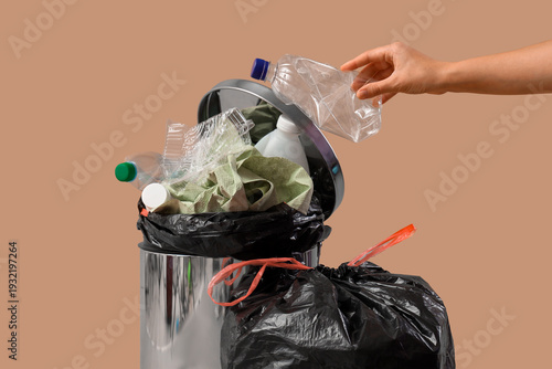 Woman throwing plastic bott...