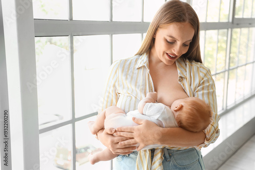 Beautiful young mother brea...