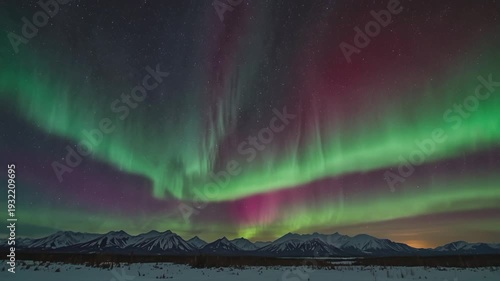 The incredible cosmic beauty of the polar regions. The dark night sky is adorned with a dramatic curtain of neon green and reddish purple light, creating a strong contrast with the sprinkling of stars