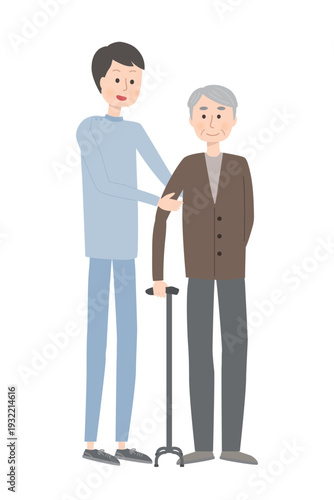 杖を使って立つ男性と支える介護スタッフ