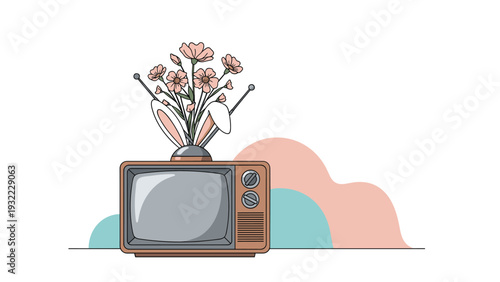Vintage television set featuring a bouquet of pink flowers and white rabbit ears growing from the top as a creative art piece.
