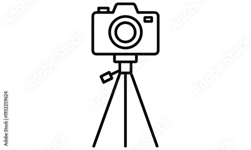 Camera mounted on a tripod for stable photography and videography applications with a flash attachment