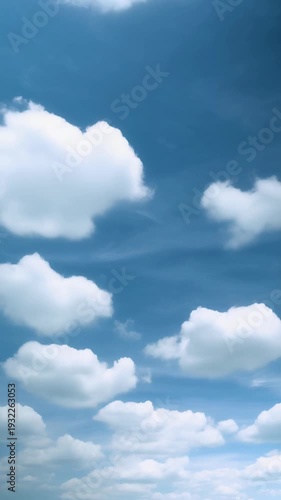 Seamless loop of white clouds drifting across a blue sky from space