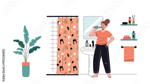 Young woman in an orange shirt is brushing her teeth in front of a mirror in a modern and organized bathroom.