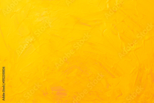 黄色い絵の具でペイントされたキャンバスの背景テクスチャー