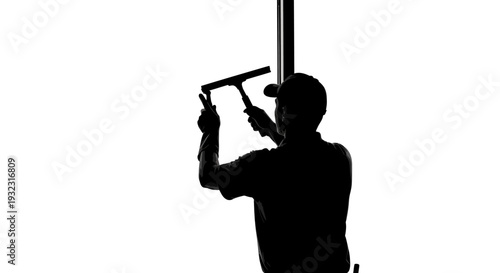 Silhouette of a window cleaner working against a bright white background
