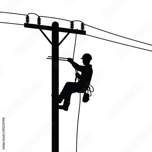 Silhouetted lineman working on a high voltage power line pole