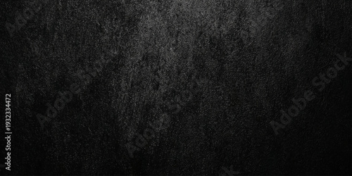 A dark wall textured background resembling rough charcoal or blackened wood grain creates a somber aesthetic