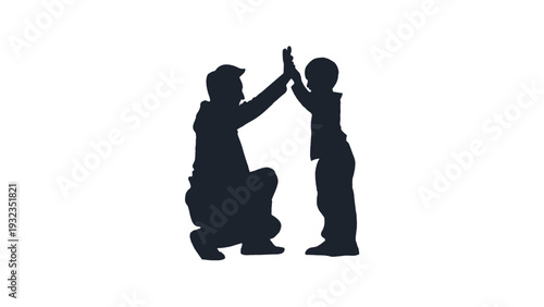 Silhouette of father and son high fiving each other