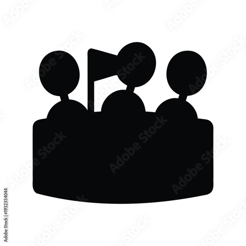 Black silhouette of a group of people behind a table and flag