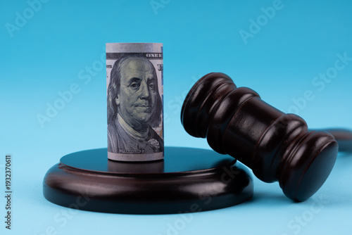 Gavel set and 100 dollar money roll law concept on blue background