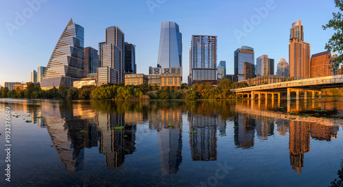 Sunset Austin - A panoramic view of soft evening sunlight shining on modern skyscrapers of Downtown Austin, at shore of Lady Bird Lake. Texas, USA.