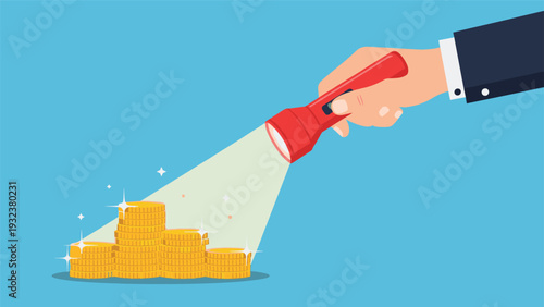 Human hand holds a bright red flashlight that illuminates several stacks of shining gold coins against a plain blue background.