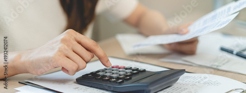 Canvas Print person using calculator calculating tax refund on the table