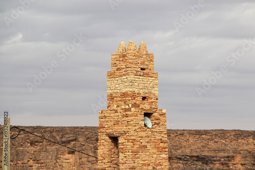 The ancient mosque of the local village close old city Ouadane in Sahara desert, Mauritania
