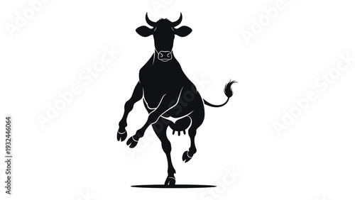 A striking black silhouette of a cow rearing up on its hind legs
