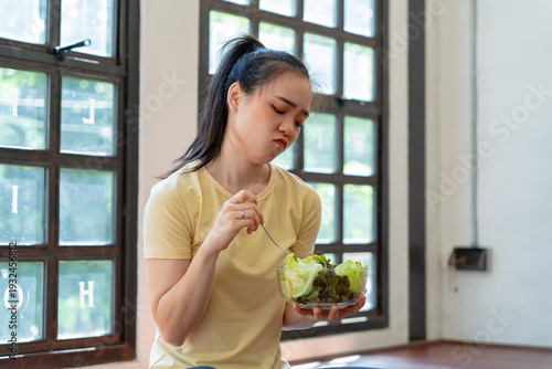 Free Download Unhappy Asian girl eating green vegetables salad upset bored of dieting. anorexia Bored  Woman with unsatisfied facial emotional - GFXLoad