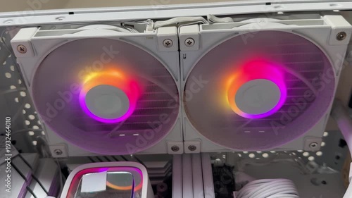 Close-up of RGB computer case fans spinning and cooling internal PC components, showing airflow and modern hardware in action.