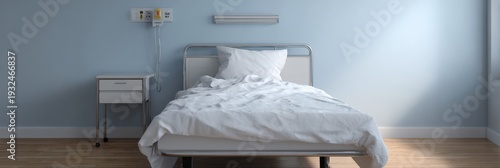 Hospital bed unoccupied rumpled linens low bedside table pale blue wall sunlight on hardwood floor simple clinical room conveying solitude and patient absence