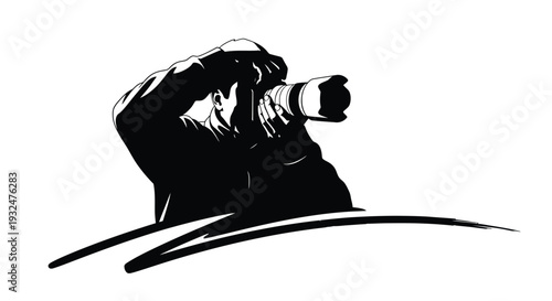 Photographer with camera capturing a moment in striking black graphic silhouette