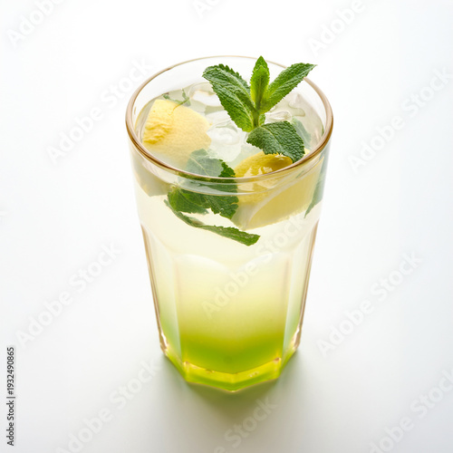 Refreshing drink with mint and pineapple served in a tall glass on a white background in a simple setting