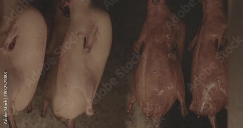 Hanging Roasted Ducks in a Traditional Cooking Setup