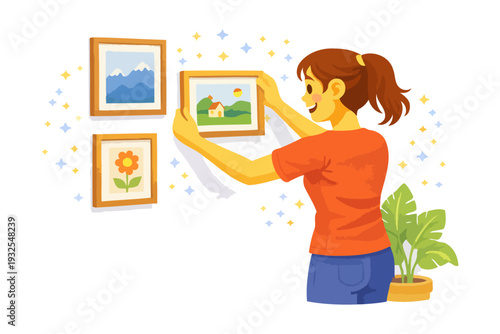 Young caucasian female arranging art on wall with plant nearby.