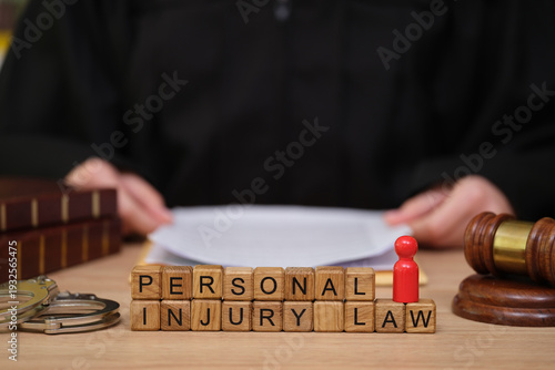 A judge sits at a desk, surrounded by legal tools and documents, engaged in a thoughtful discussion about personal injury law. The atmosphere is serious and focused.