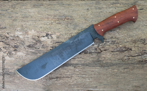 Machete knife lies on the wooden floor