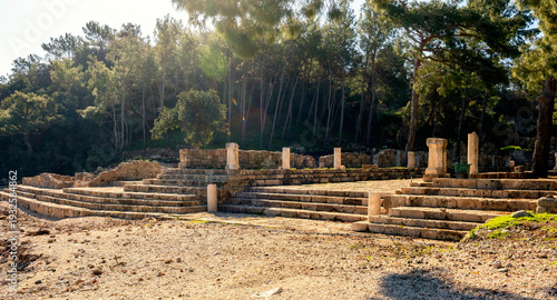 Phaselis ruined building with a tree growing through it near the coast.  Phaselis antic archeologic site in Turkey Kemer Antalya.The ancient site of Phaselis lies 58 km south of Antalya on an isthmus 
