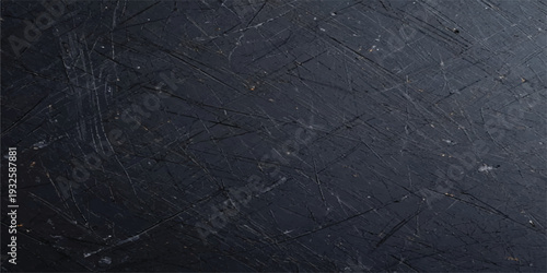 Scratched dark industrial surface with white marks and dirt, a grungy textured background for rugged and edgy themes.