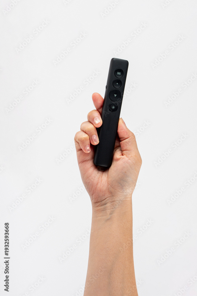 custom made wallpaper toronto digitalA small black remote control in a hand, against a white background.