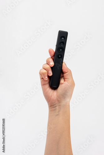 Wallpaper Mural A small black remote control in a hand, against a white background. Torontodigital.ca