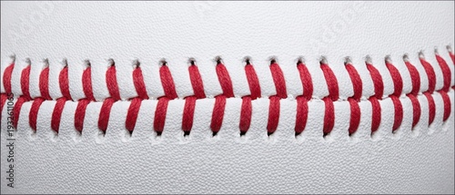 The baseball seam closeup showing red stitching and textured white leather surface