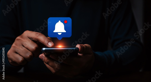 Notification bell icon on a smartphone screen in a dark setting