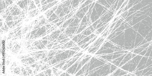 Chaotic white scratches and lines overlaying a textured gray background creating a distressed abstract pattern