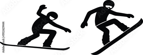 Snowboarders in dynamic motion on snowy slopes