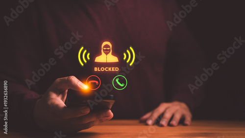 Hand using smartphone to block scam call. Cyber security protection against fraud, phishing, and hacker threats. Mobile phone user stopping spam.