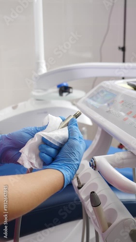 Medical nurse cleaning and disinfecting dental tools. Equipment being cleaned by assistant in modern dental clinic. Preparing dental office before treating patients. Vertical footage. 4 k video