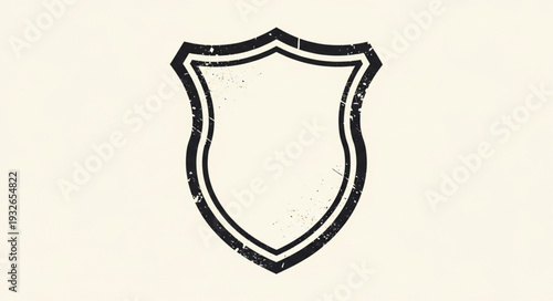 Simple shield emblem with a black outline on a white background, classic design.