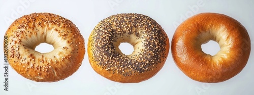 Wallpaper Mural Three golden brown bagels on white background, sesame, everything, and plain, fresh and appetizing Torontodigital.ca