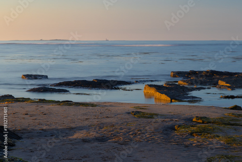 Late Evening Light at Beadnell Bay with the Farne Islands on the horizon, Northumberland, England, UK.