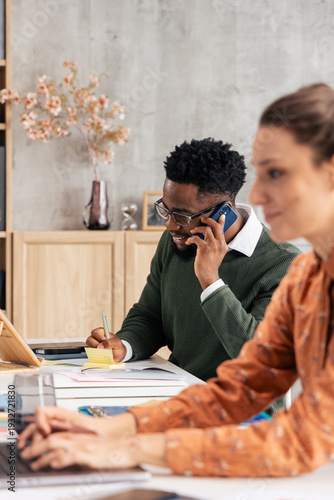 Diverse colleagues working and communicating in an office