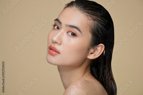 Wet Hair Portrait of Young Asian Woman on Plain Background