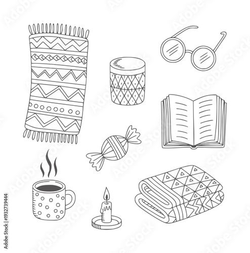 Cozy hygge including blanket coffee cup book candle and glasses