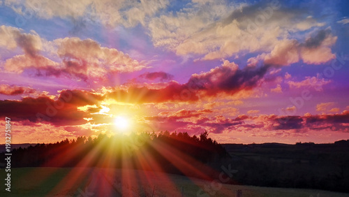 Colorful sunset background with abstract clouds and trees.